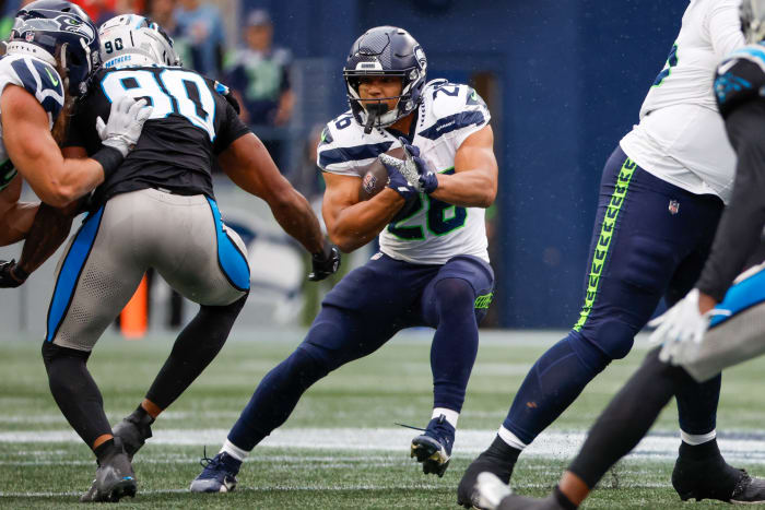 Seattle Seahawks running back Zach Charbonnet (26) rushes against the Carolina Panthers during the fourth quarter at Lumen Field.